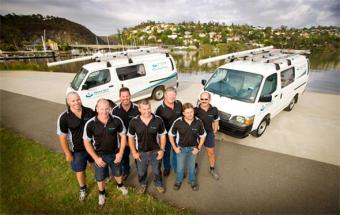 part of our plumbers in Kendall standing ready by their trucks